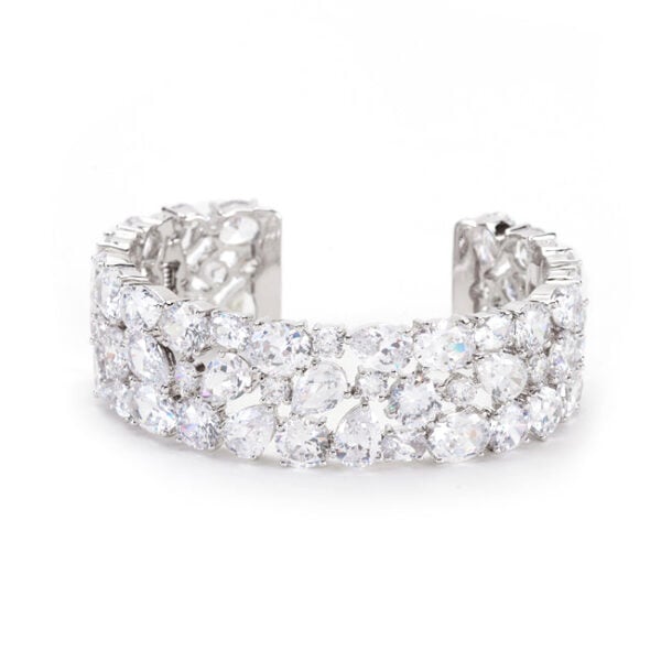 Cubic zirconia cuff bracelet with oval and round cubic zirconia in prong settings, rhodium plated over lead free alloy (brass).