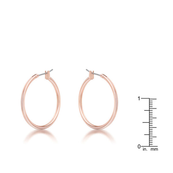 Close-up of a single small rosegold hoop earring highlighting its open hoop shape