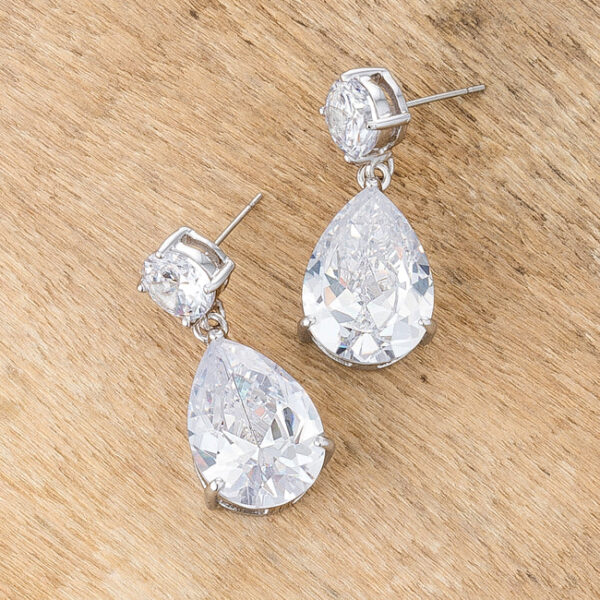 Angled view of the stud earrings showing the white-toned metal setting around both stones