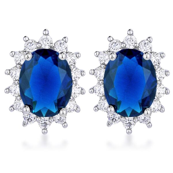 Pair of rhodium plated oval earrings with blue stones set at the center