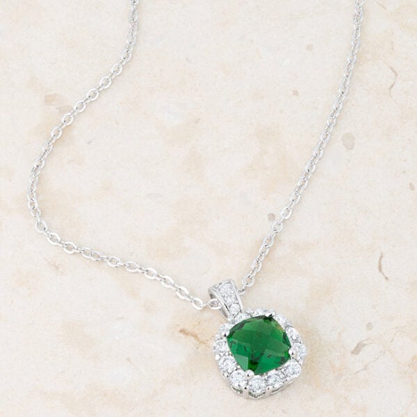 Rhodium plated over lead free alloy (brass) pendant with emerald-colored cubic zirconia.