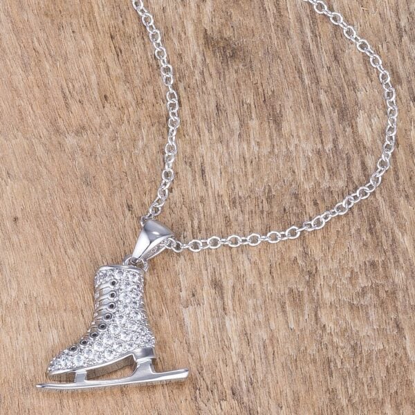 Round clear pave-set stones on an ice skate pendant in rhodium plated over lead free alloy (brass)