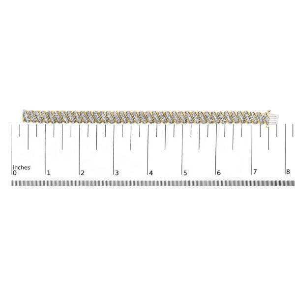 Yellow gold diamond bracelet shown next to a ruler for scale reference