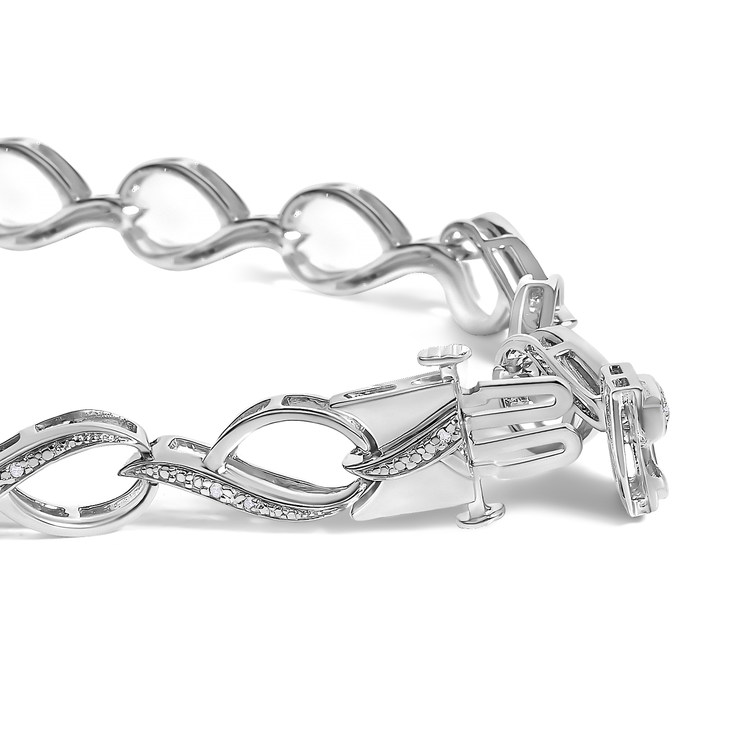 Close-up of swirl links showing prong-set round diamonds and the rhodium plated finish