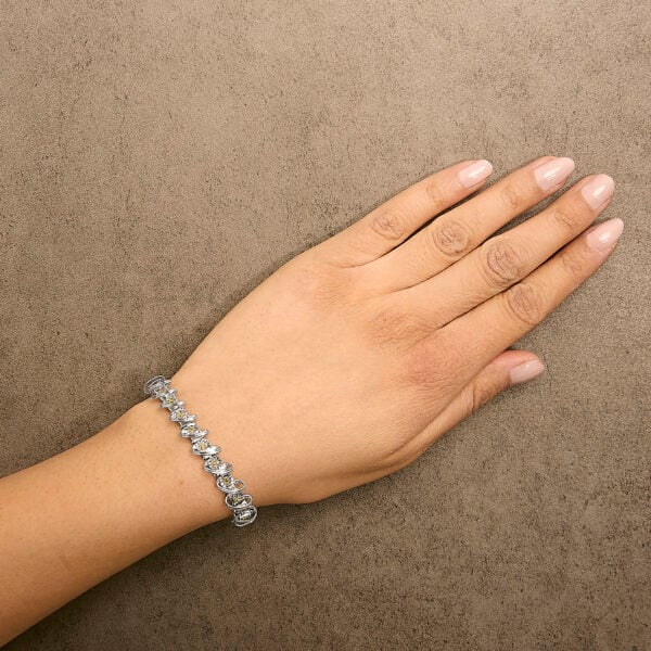 Bracelet worn on a wrist showing the yellow diamonds and link drape