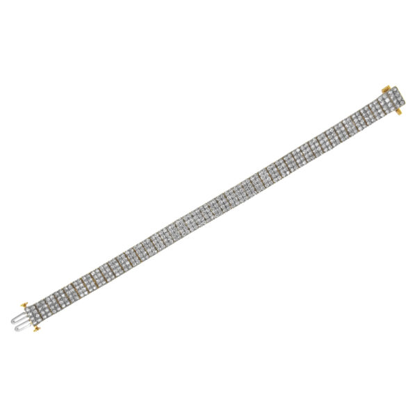 Bracelet coiled into a loop showing its flexible construction and 14K yellow gold plated tone