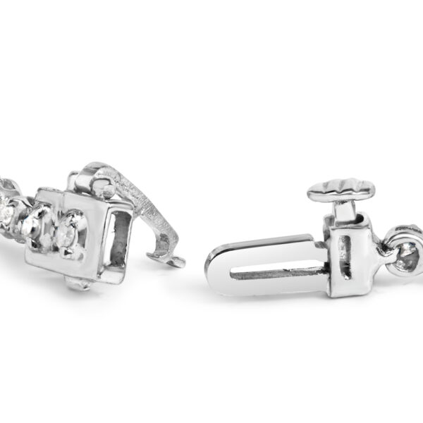 Close view of round diamonds in prong settings along the sterling silver bracelet band