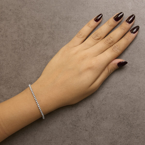 Diamond tennis bracelet worn on a model's wrist