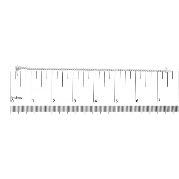 Diamond tennis bracelet shown next to a scale reference to indicate its size