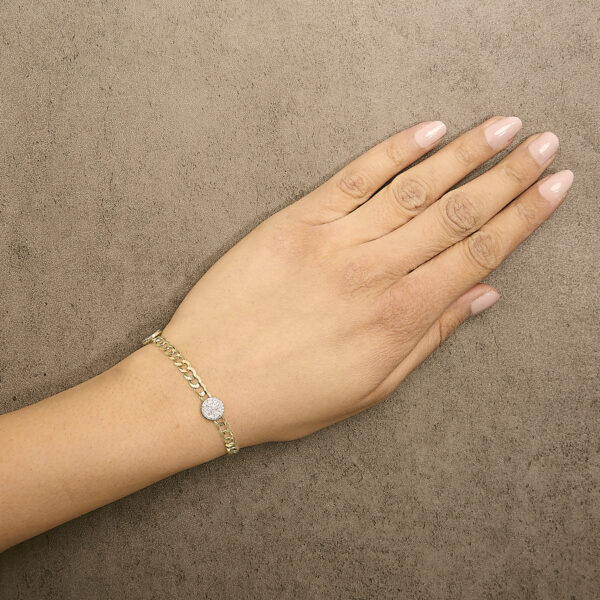 Bracelet worn on a wrist, showing the curb chain and diamond clusters in place