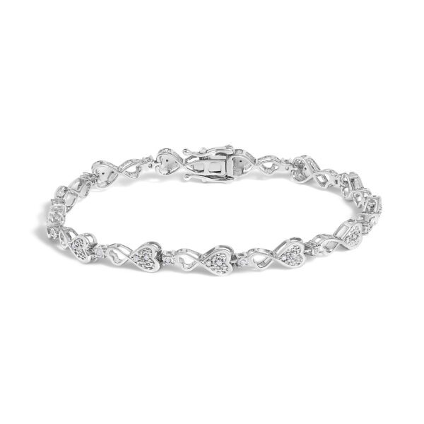 Rhodium plated sterling silver bracelet with heart-shaped links set with round diamonds, laid flat