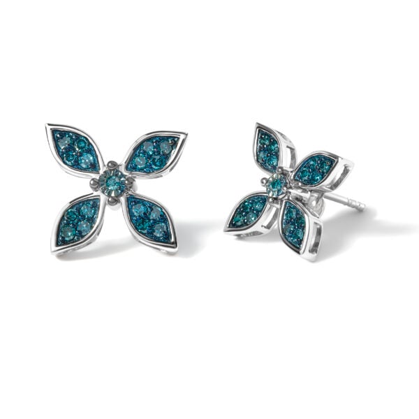 Close-up of a single floral earring showing the prong-set blue diamonds and metal finish