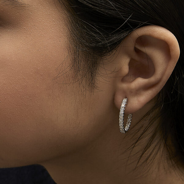 Model wearing the princess-cut diamond inside out hoop earrings