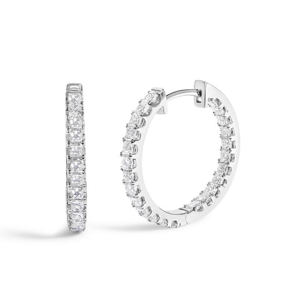 Pair of white gold hoop earrings with princess-cut diamonds set along the front edge