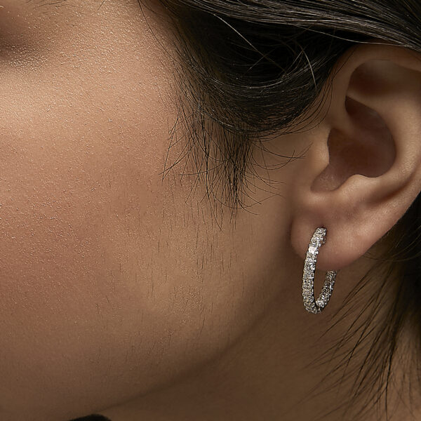 Hoop earrings shown worn on a model's ear
