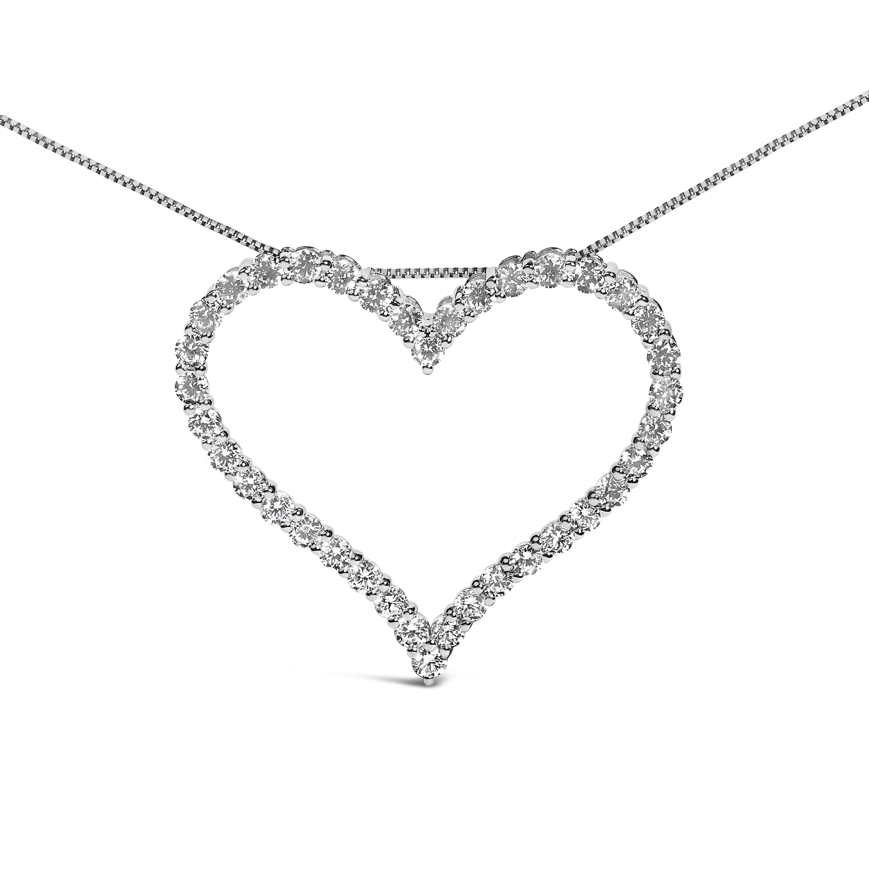 Close-up of the shared prong setting holding round diamonds along the heart pendant