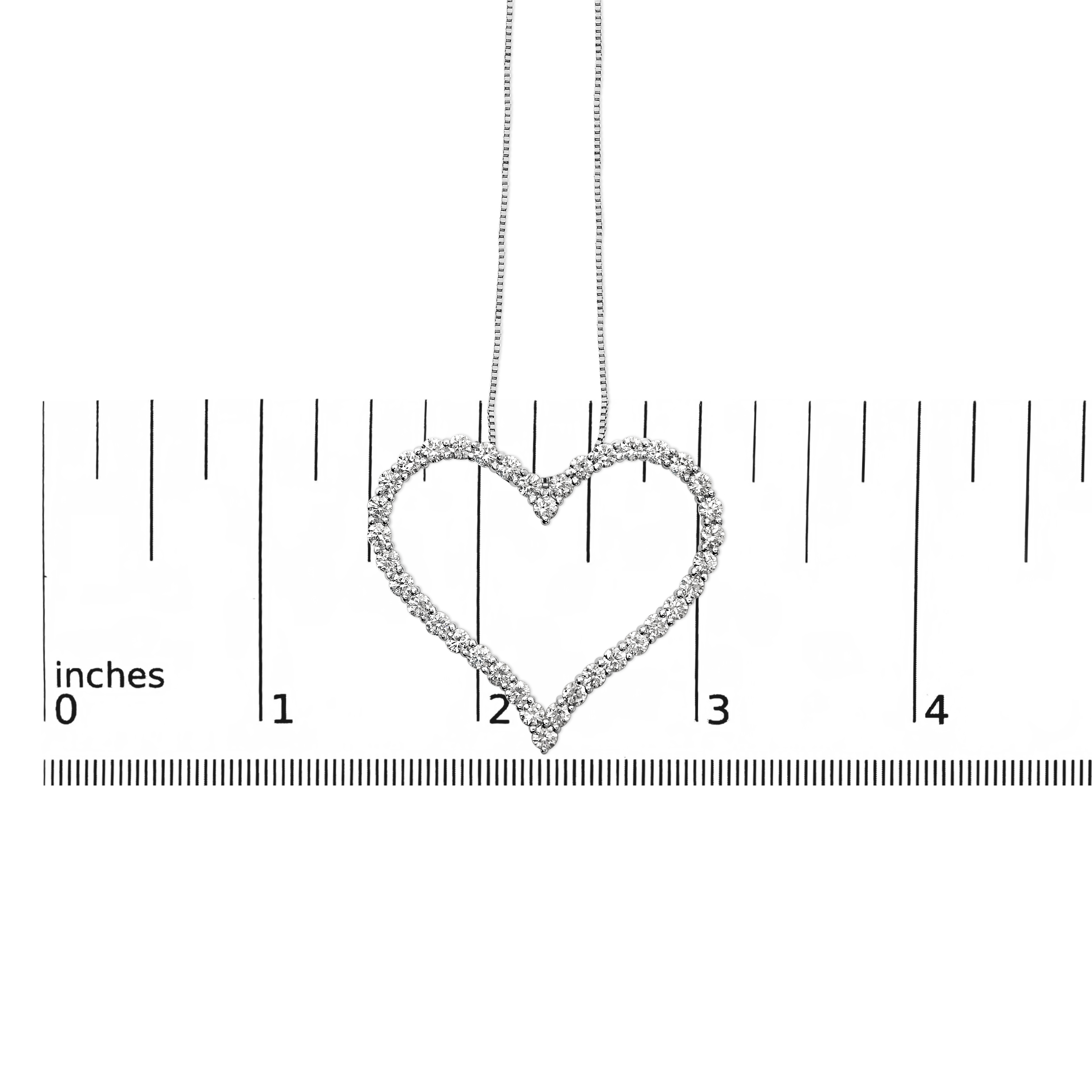 Open heart pendant necklace shown next to a scale reference for size