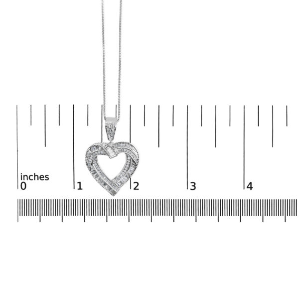 Open heart pendant shown next to a scale reference to indicate its size