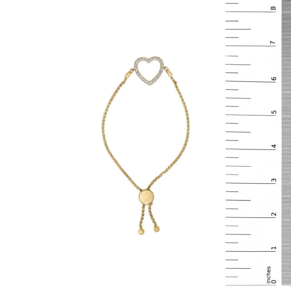 Gold vermeil bolo bracelet laid flat next to a ruler for scale reference