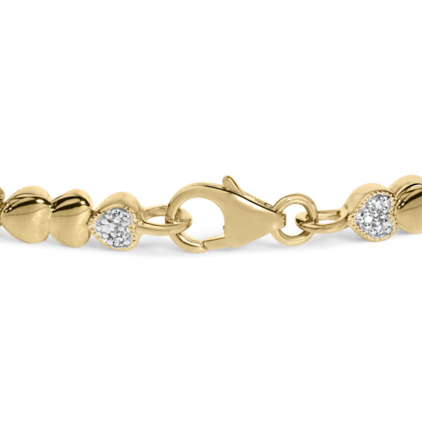 Close-up of a single puffed heart station showing pave-set round diamonds
