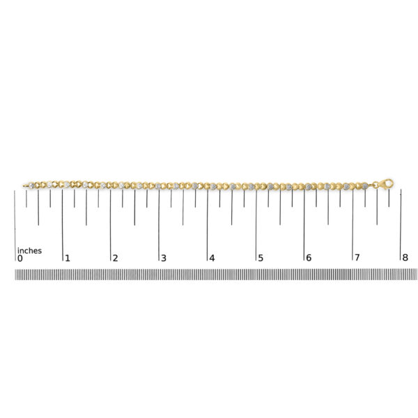 24K gold plated bangle bracelet photographed next to a ruler for scale reference