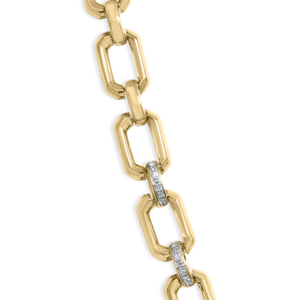 Close-up of yellow-tone octagonal links joined by diamond pave connectors