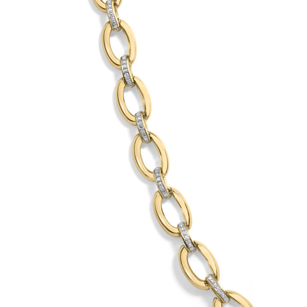 Close-up of oval links showing high-polish vermeil surface and diamond pavé connector detail