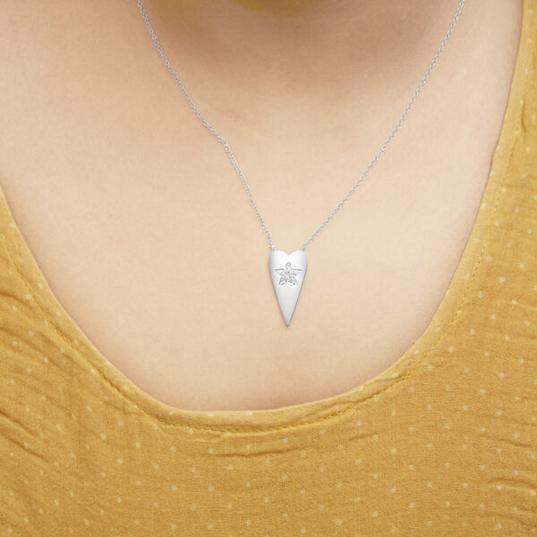 Necklace worn on a model, resting at the collarbone
