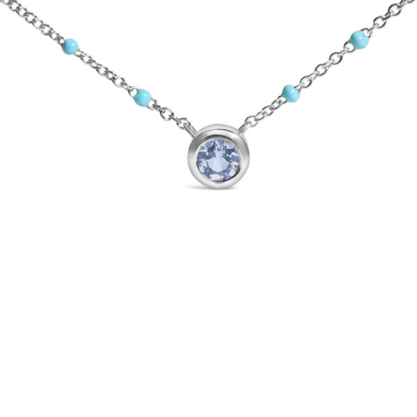 Close view of the round aquamarine held in a bezel setting on the chain