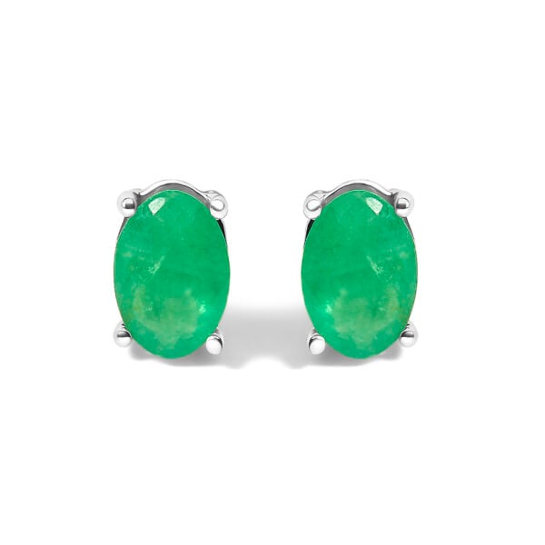Pair of oval green emerald stud earrings in a rhodium plated sterling silver 4-prong setting