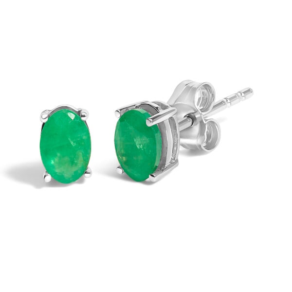 Close-up of a single oval green emerald stud earring showing the prong setting and push back