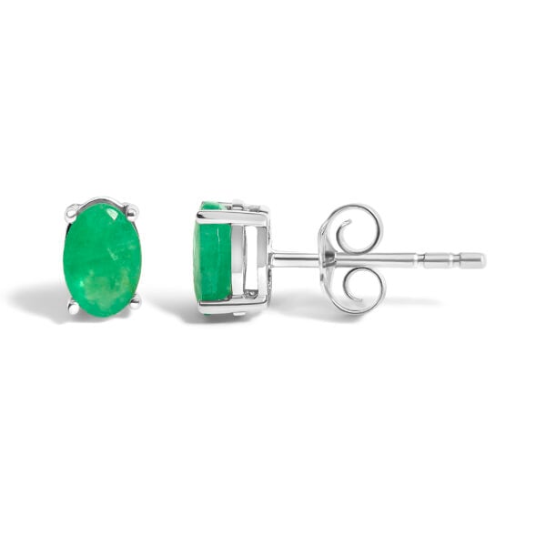 Side angle of the oval emerald stud earrings showing the open gallery beneath the stone