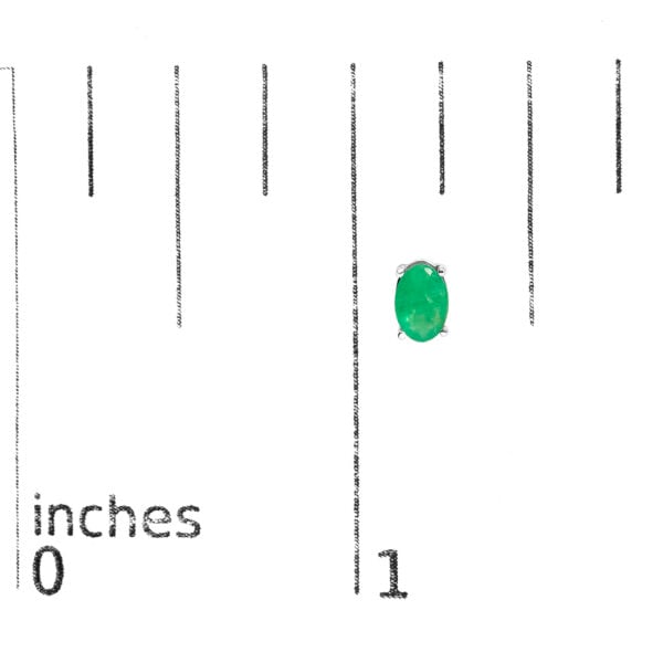 Oval green emerald stud earrings shown next to a scale reference for size comparison
