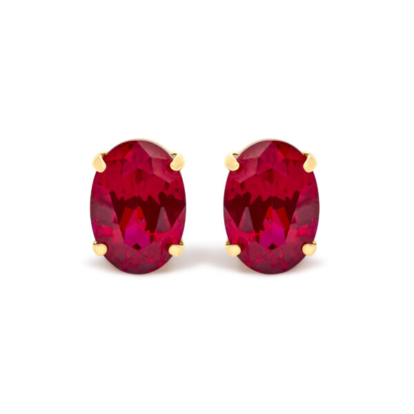 Pair of 18K yellow gold stud earrings, each set with an oval red ruby in a 4-prong mounting
