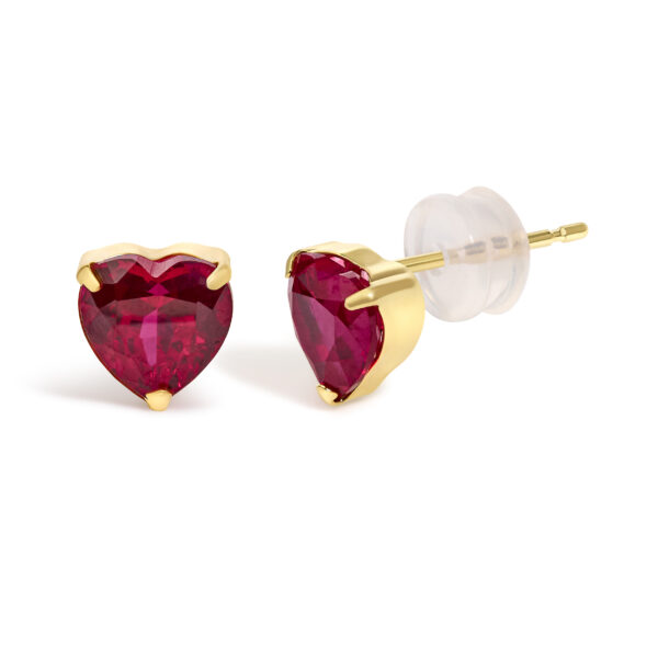 Side angle of an 18K yellow gold ruby heart stud earring showing the prong setting and post