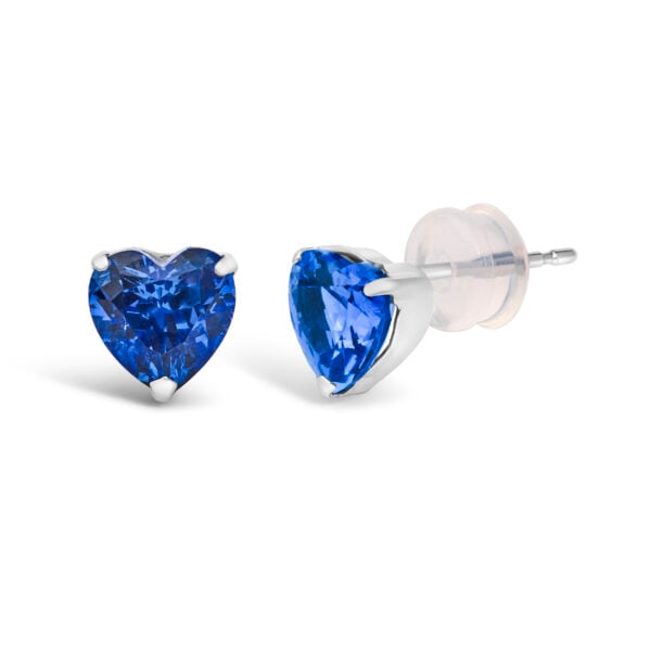 Platinum heart sapphire stud earrings shown at an angle to display the prong setting