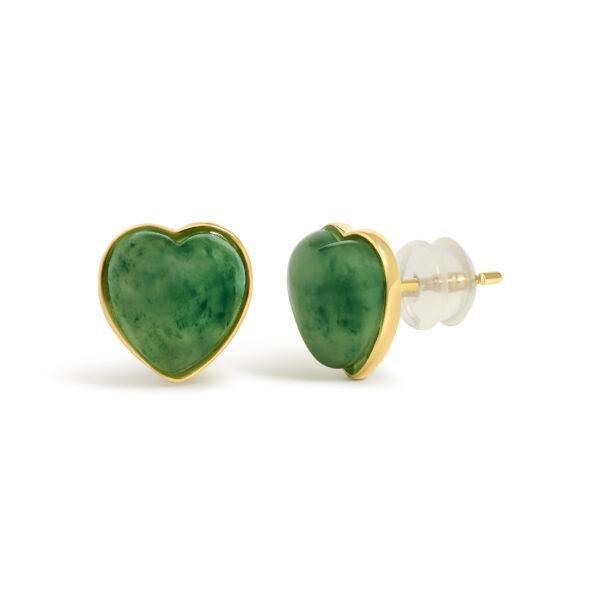 Close-up of one green jade heart stud earring showing the gold bezel rim around the stone's edge