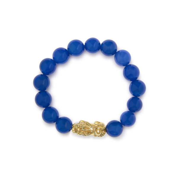Gold dragon charm shown from the side against the beaded strand