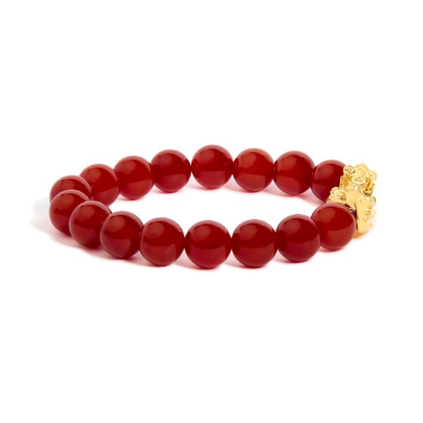 Close view of the gold dragon charm among red agate beads
