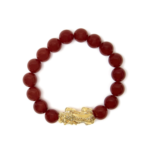 Red agate beads shown in close detail with drilled stringing holes visible
