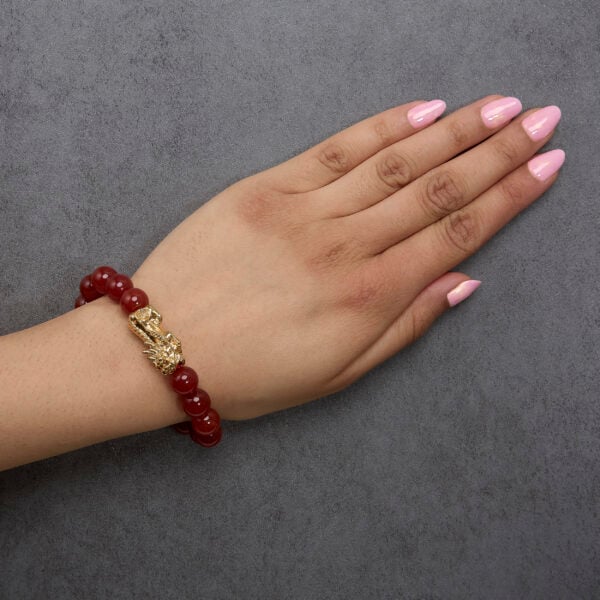 Bracelet worn on a wrist showing the dragon charm and agate beads in place