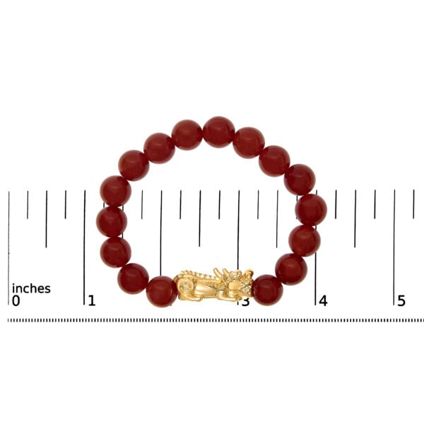 Bracelet laid flat next to a ruler showing its sized length