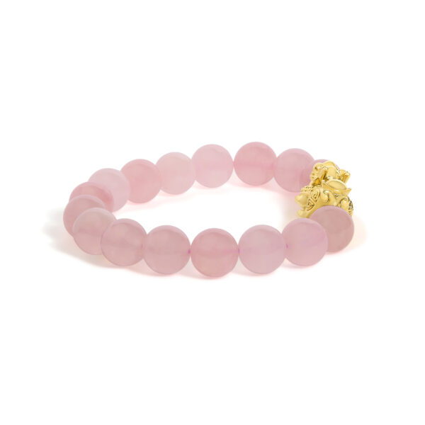 Close view of the gold dragon charm's sculptural detail on the beaded bracelet