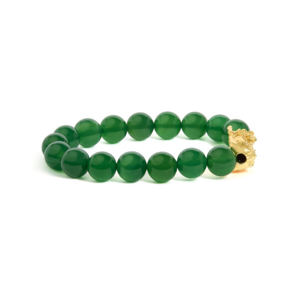 Close-up of the 18K yellow gold dragon charm on the agate bead bracelet