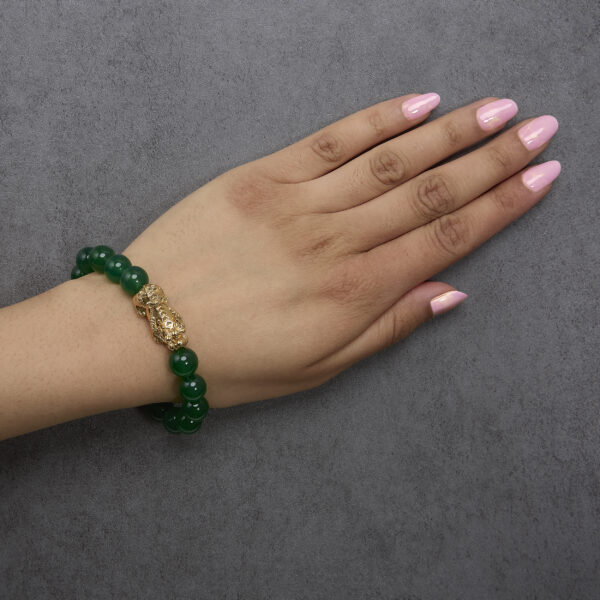 Bracelet worn on a wrist, showing the agate beads and dragon charm in place