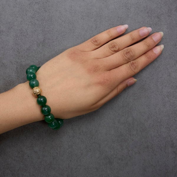 Aventurine beaded charm bracelet worn on a wrist