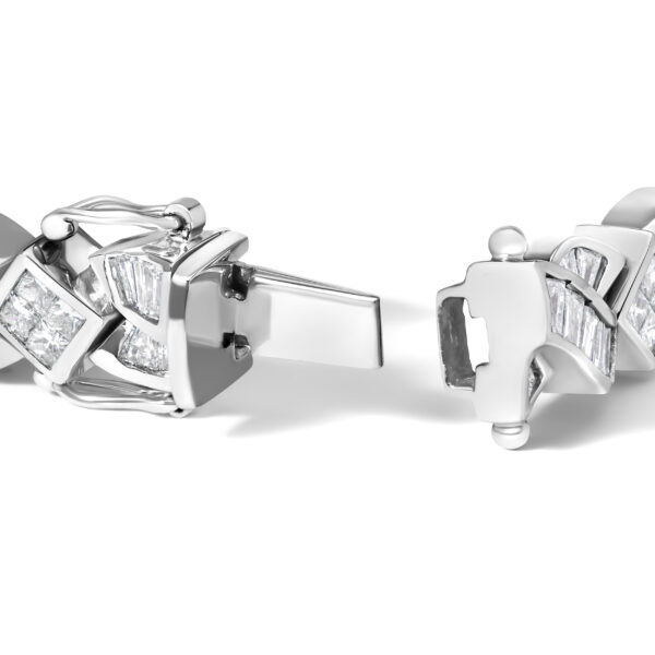 Close view of the twisted link bracelet showing channel-set baguette diamonds along the metal links