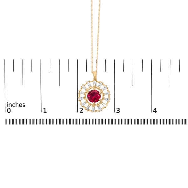 Pendant photographed next to a scale reference showing its size in inches