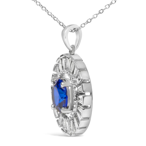 Side view of the pendant showing the prong setting holding the round blue stone above the diamond halo