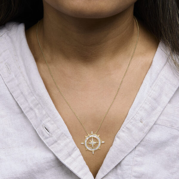 Compass pendant necklace worn, showing how it sits on the chain